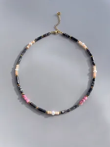 Detail of handmade necklace with natural stones, marble beads and freshwater pearls