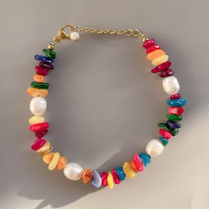 Macro shot of colorful natural stones and baroque pearls on a handmade beaded bracelet