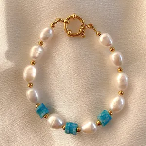 Detail of baroque freshwater pearl bracelet with blue patterned beads and gold clasp