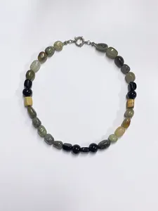 Detailed close-up of natural multicolor stone beads with silver metallic spring clasp