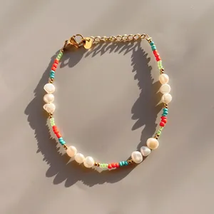 Detail of colorful beaded bracelet with baroque pearls and golden lobster clasp