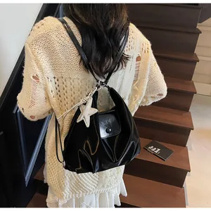 Detailed back view of a black glossy PU leather hobo bag with star charm on a shoulder
