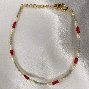 Detailed macro view of handmade beaded bracelet with freshwater pearls and colorful stones