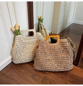 Détail du sac cabas en paille tissé main avec anses en bois tons crème et marron