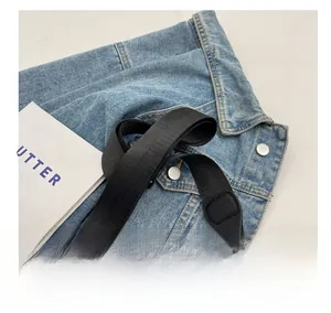 Detail of adjustable black nylon shoulder strap with durable silver metal buckle