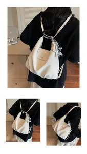 Close-up of cream-colored pleated PU leather backpack with a silver sequin star charm