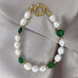 Macro shot of freshwater baroque pearl bracelet with green agate beads and golden OT clasp