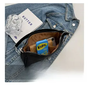 Interior view showing the storage capacity of the black nylon half-moon shoulder bag