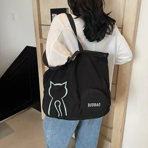 Large black canvas tote bag with green cat print and round zip pocket for women