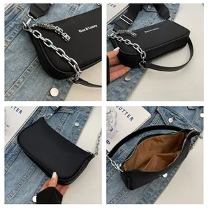 Detail view of black nylon shoulder bag with silver chain and wide adjustable strap