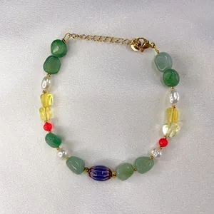 Detail of colorful natural stone and freshwater pearl beaded bracelet with gold lobster clasp