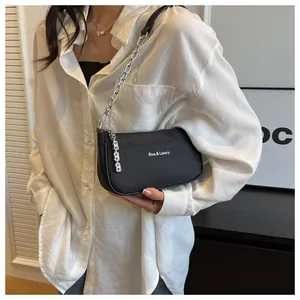 Close-up of black nylon shoulder bag featuring silver metal chain and Rica Luxury text