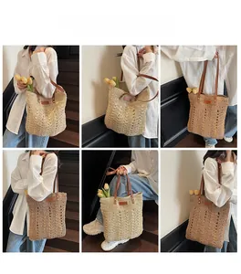 Detailed view of woven straw tote bag with leather straps and texture closeup
