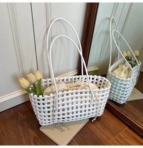 Detail of white hollow woven tote bag with a drawstring inner pouch on a wooden floor