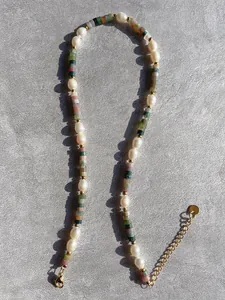 Detailed close-up of handmade freshwater pearl and colorful natural stone beaded necklace