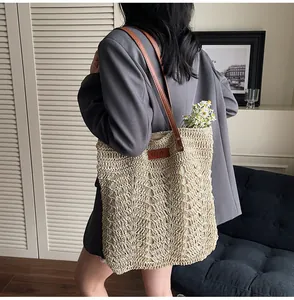 Close-up of beige crochet straw tote bag with brown leather handles and interior daisies