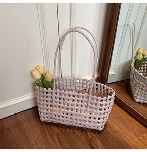 Macro detail of the lavender hand-woven texture and elegant grid pattern on the tote bag