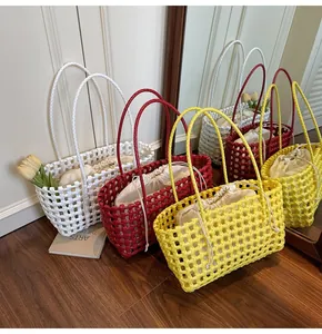 Detail of hollow woven basket bags in three colors with canvas drawstring lining