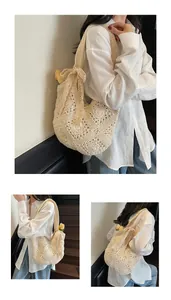 Detail of hand-woven cream crochet shoulder bag featuring a decorative bow and hollow pattern