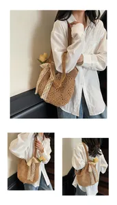Detail of straw woven tote bag featuring a large cream lace bow and floral decoration