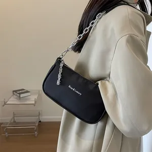 Minimalist black nylon shoulder bag with silver chunky chain and Rioa Luxury lettering