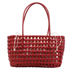 Red woven cutout tote bag with white canvas drawstring liner and slim shoulder straps