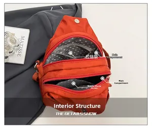 Detail view of the orange canvas backpack interior with two main pockets and zip pocket
