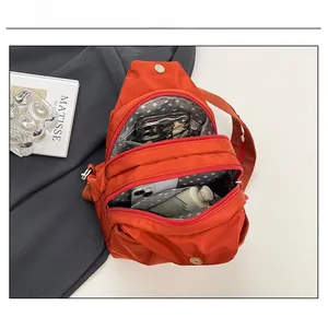 Internal capacity of orange canvas backpack with polka dot lining and zip storage