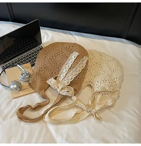 Detail of hand-woven hollow crochet shoulder bag featuring lace bow and floral patterns