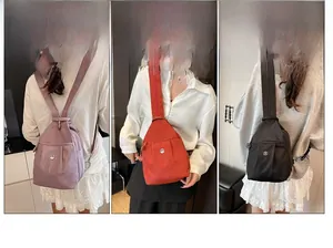 Three nylon sling bags in purple, red, and black with multi-pocket and zip strap design