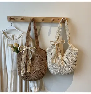Detail of hand-woven crochet tote bags with lace bows in brown and beige tones