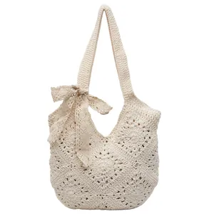 Handmade crochet shoulder bag in cream white with floral patterns and lace bow accents