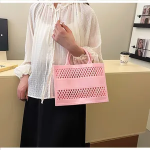 Detail of pink hollow-out jelly tote bag showing diamond mesh pattern and flexible texture