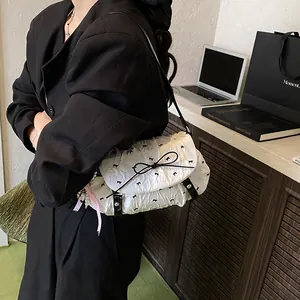 White pleated shoulder bag with black bow prints and pearl charm for casual summer style