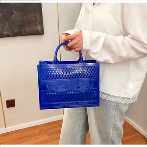 Detailed side view of dark blue hollow-out jelly tote bag with woven mesh design