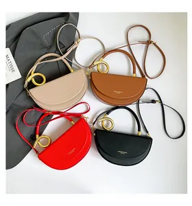 Flat lay of four leather saddle bags in beige, brown, red and black with spiral handles