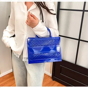 Detail of blue hollow-out tote bag with diamond lattice pattern for summer beach use
