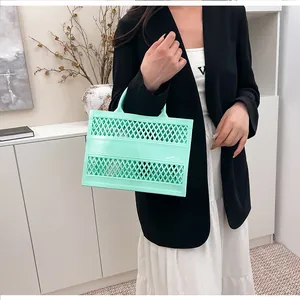 Detail view of mint green jelly bag with hollow diamond pattern and soft plastic texture