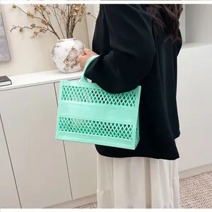 Close-up of mint green hollow-out beach bag made of flexible waterproof plastic