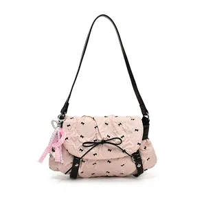 Pink pleated balletcore shoulder bag with black bows and pearl charm accessory