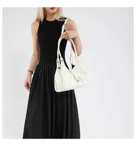 Polished white lacquer hobo bag detail with golden metal buckle and adjustable strap