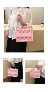 Detail of pink hollow-out mesh jelly beach bag with comfortable curved handle