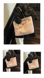 Detail of light pink tote bag with bear charm and marble texture on wooden stairs