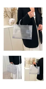 Detail of transparent PVC tote bag with lattice pattern and clear top handles
