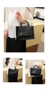 Detail of black hollow mesh jelly tote bag with iconic horizontal band and double handles