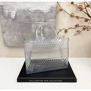 Detail view of transparent jelly tote bag featuring hollow lattice patterns and sturdy handles