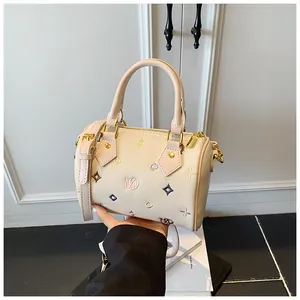 Detail of floral embroidery and MD logo on cream-white Boston bag with gold hardware