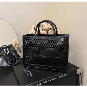 Detail of black hollow-out jelly tote bag with rhombus mesh design in a premium display