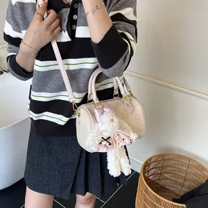 Creamy Boston handbag with animal embossing and a large plush rabbit charm accessory