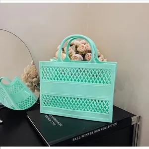 Close-up of mint green hollow beach tote bag with diamond grid pattern and top handles